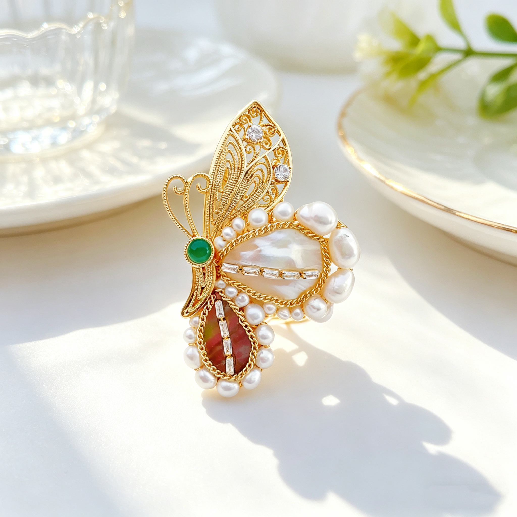 A golden butterfly-shaped jewelry brooch for women, featuring a unique ethnic style and silver jewelry inlaid with pearls