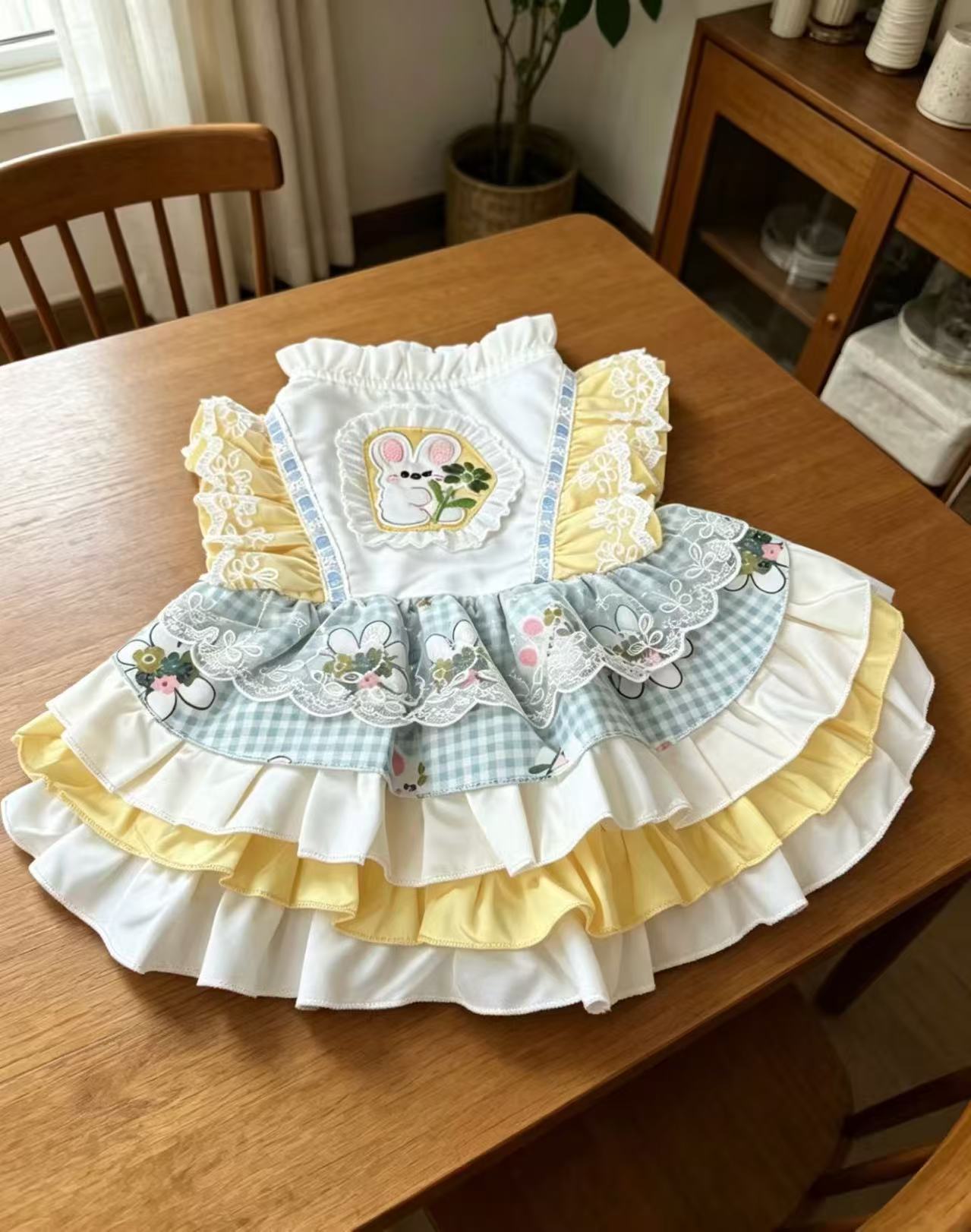 A yellow and white contrasting pet dress with cartoon patchwork embroidery and multi-layered lotus leaf lace, creating an atmosphere for daily photos Item Picture