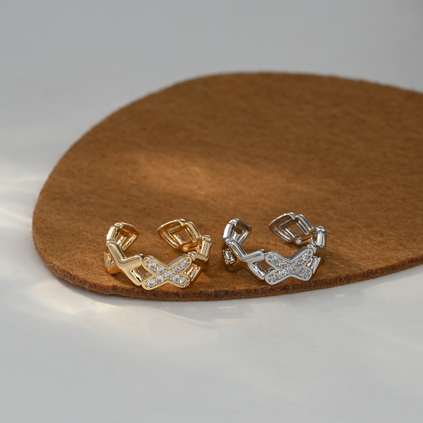 A cute, fashionable and versatile golden diamond-encrusted X-shaped hollowed-out ring
