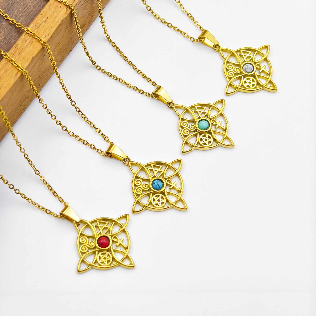 A golden Celt-style stainless steel pendant necklace with natural stone embellishments and chains, exquisitely and elegantly pieced together as a stylish accessory