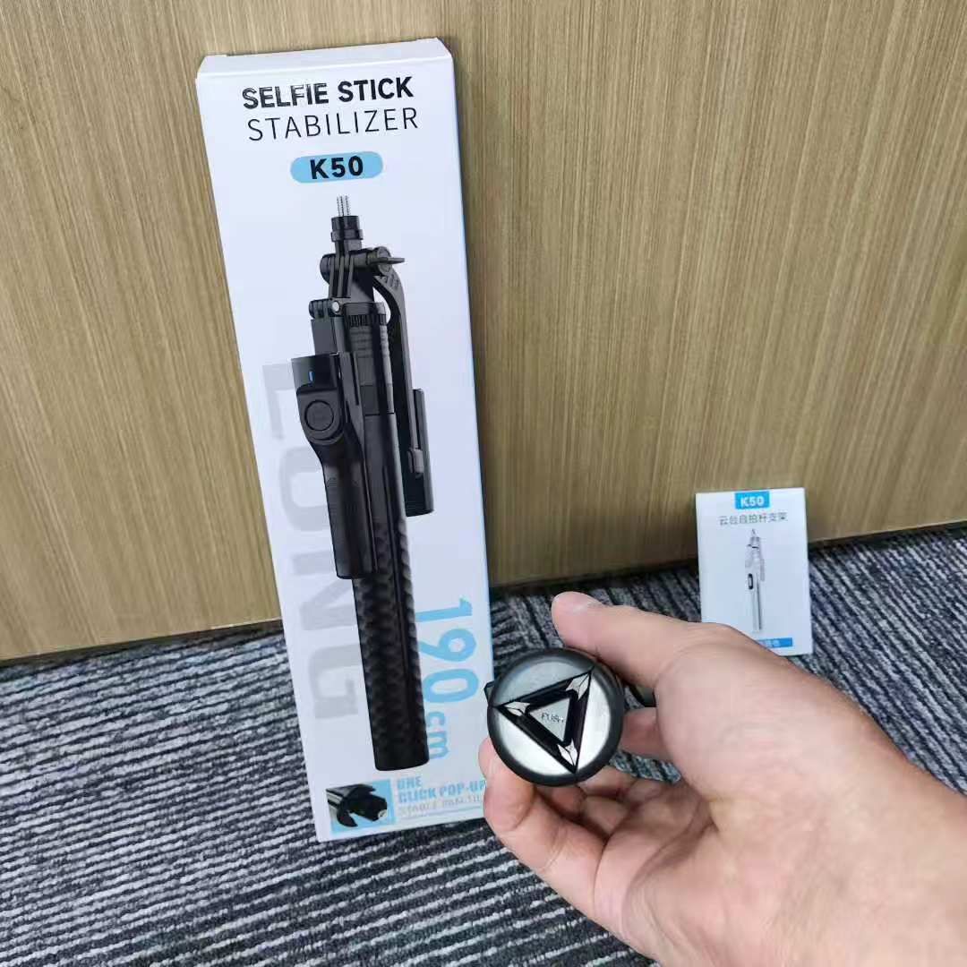 The best-selling K50 mobile phone selfie stick is a universal live streaming ground phone stand with a handheld stable shooting and anti-shake three-legged selfie stick