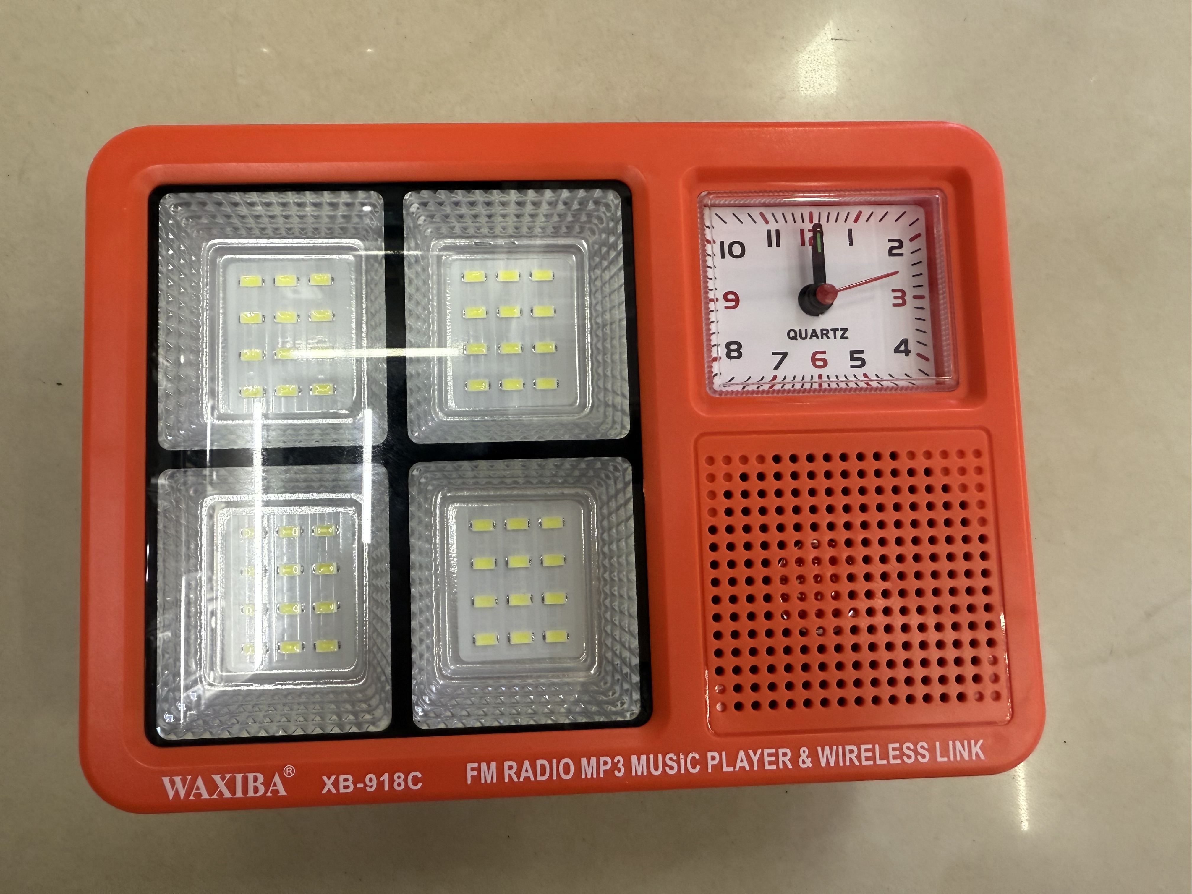 The XB-918C solar panel radio with a clock and light can be used for lighting in the wild, camping, outdoor equipment, emergency disaster relief, FM Bluetooth speaker, USBTF card to play music, external power supply, and multi-functional photovoltaic panel