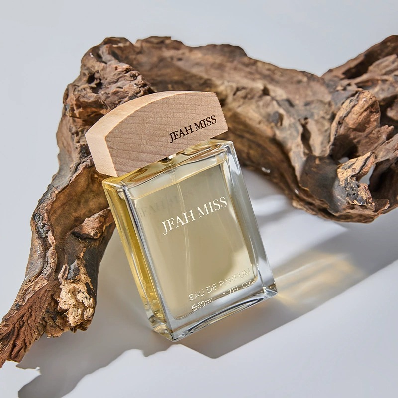 A transparent glass perfume bottle with a wooden cap, decorated on a dead wood, is a shell Jesus mural hanging art decoration