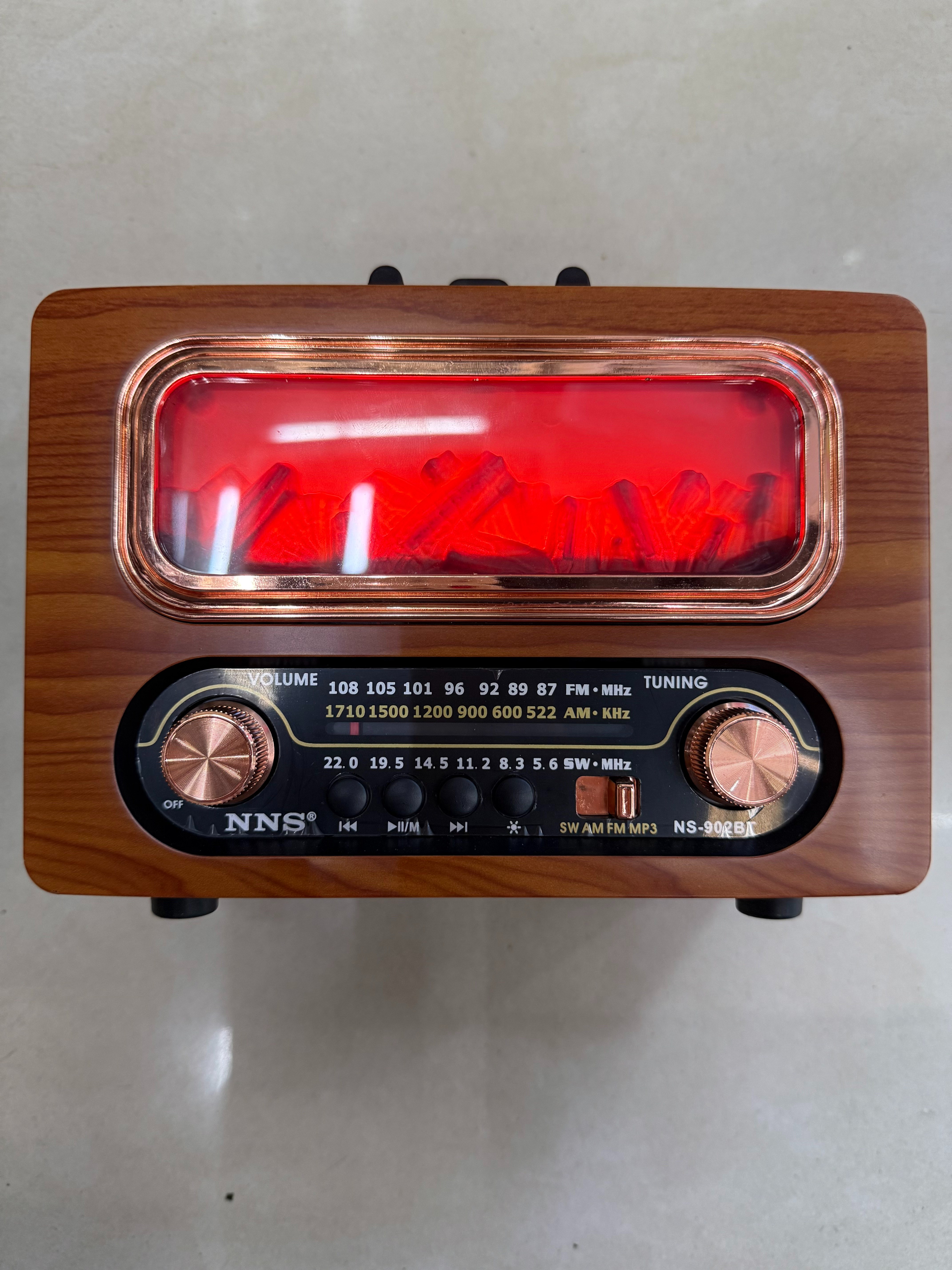 NS-902BT, a new retro radio Bluetooth speaker, features a wood-grain firewood-shaped design with a light, multi-band and multi-functional desktop decoration, USB music, and a TF card for playing music. It is suitable for giving as a gift to the elderly