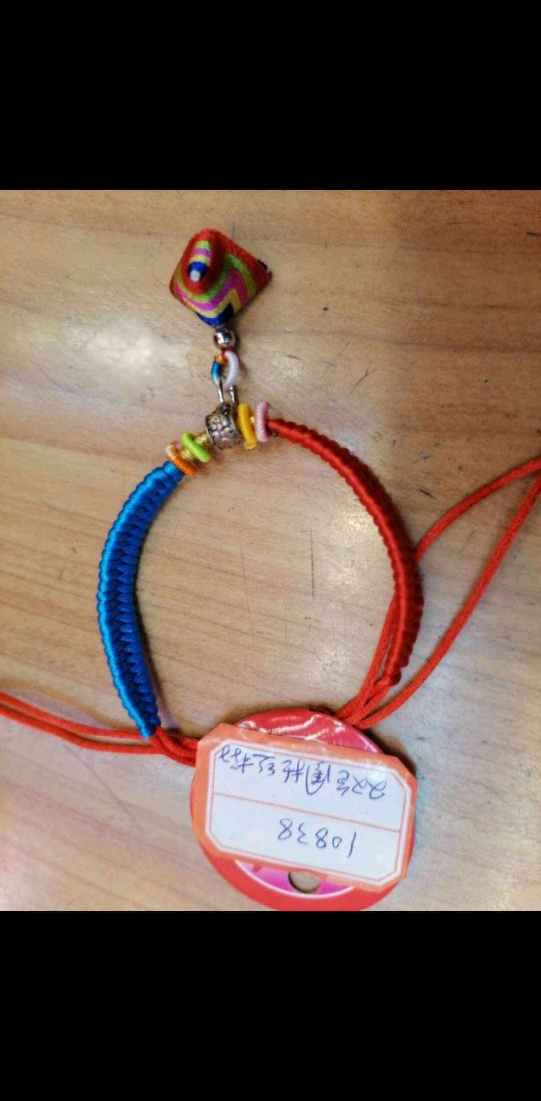 A two-color string bracelet for the Dragon Boat Festival is hung with a lucky ball of zongzi Application Scenario