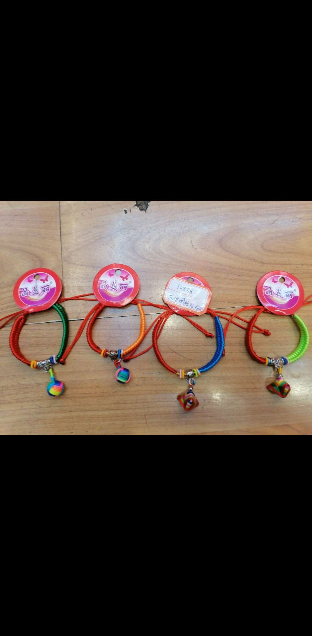 A two-color string bracelet for the Dragon Boat Festival is hung with a lucky ball of zongzi details Picture