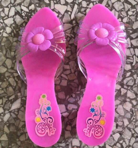 The girl in high heels is playing house with toys details Picture