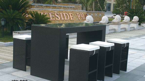 The bar counter features imitation rattan bar stools and a large rattan bar table