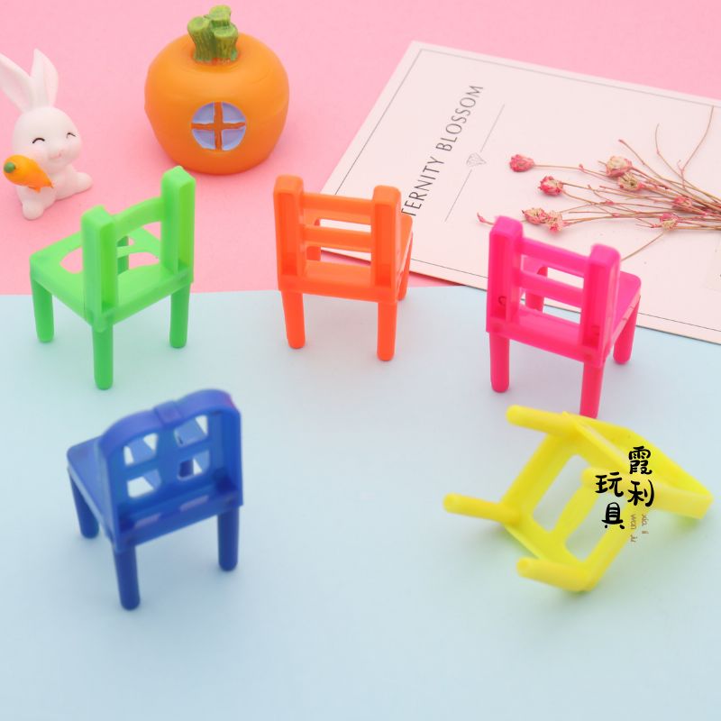 A plastic toy with a small chair for playing house as a gift details Picture