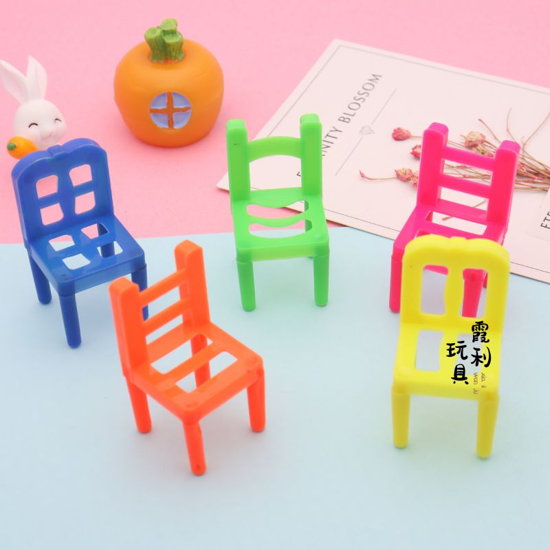 A plastic toy with a small chair for playing house as a gift