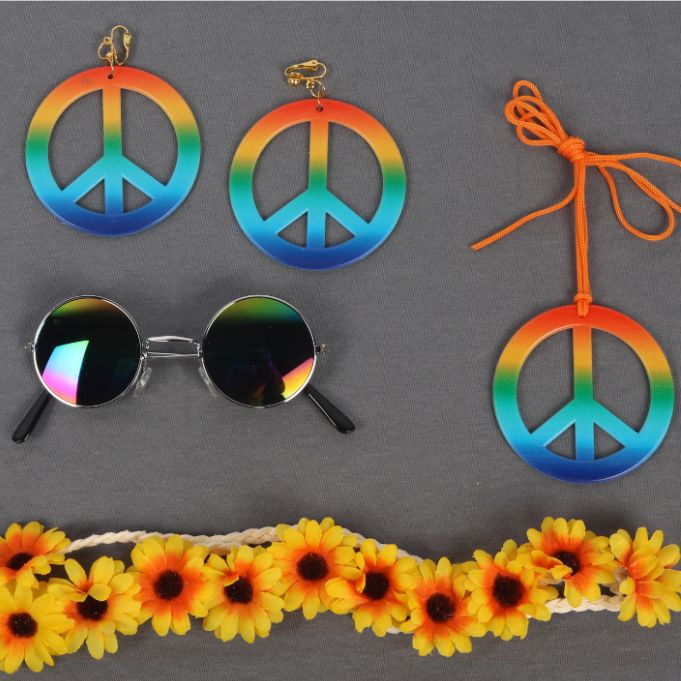 An orange sunflower wears a colorful peace necklace, earrings, glasses and a masquerade ball suit