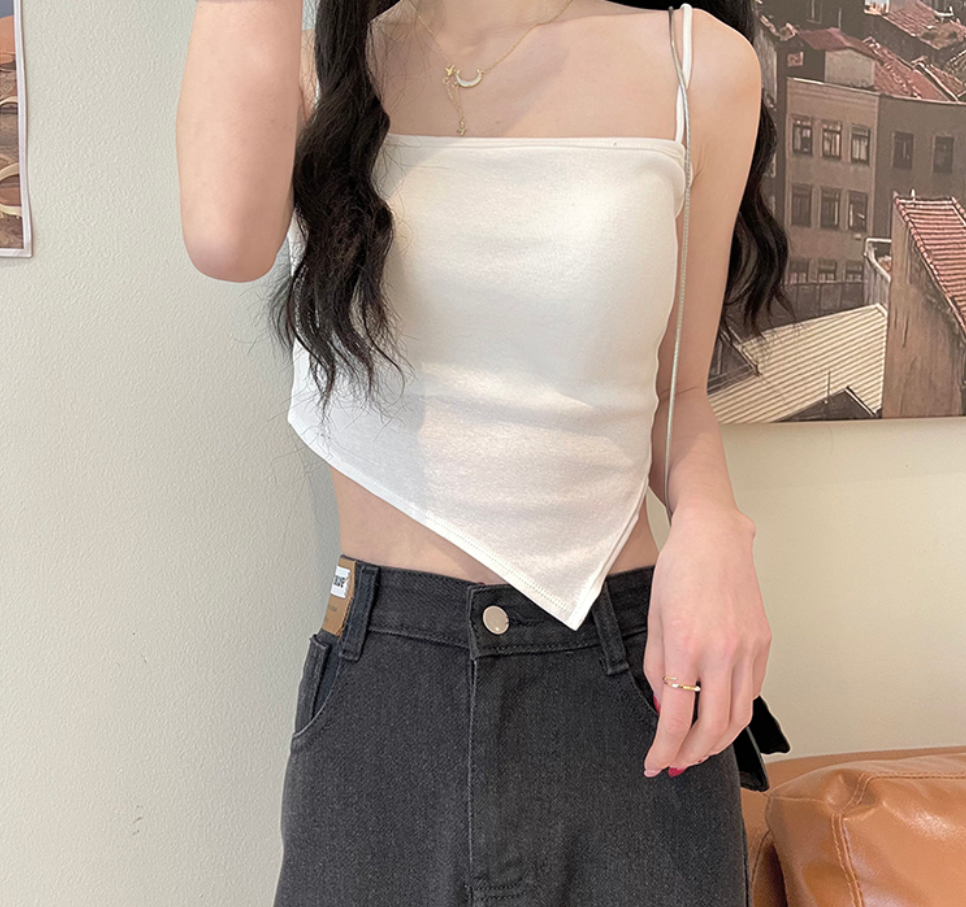 A short white halter top is worn inside as a women's anti-exposure off-the-shoulder bra with a chest pad for autumn details Picture