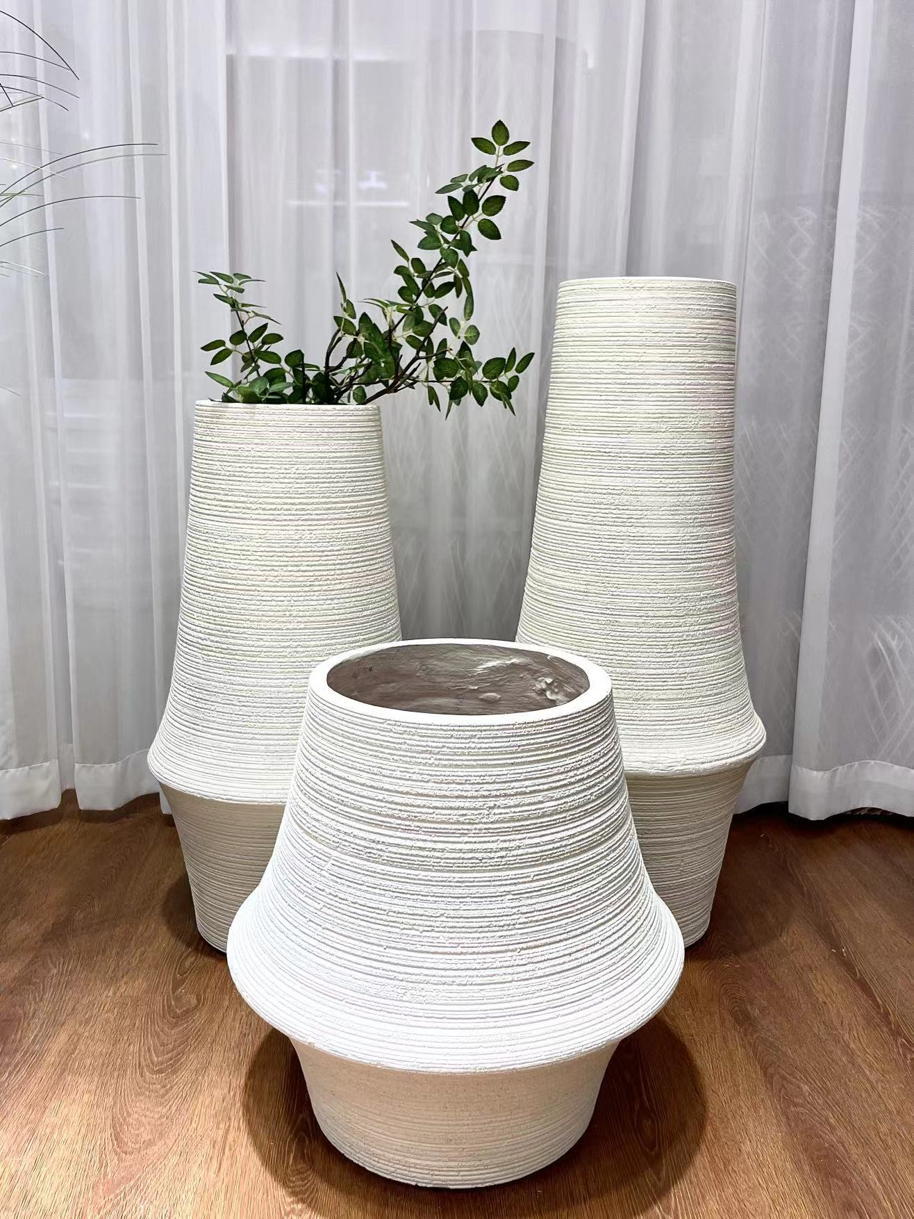 A simple beige magnesium oxide horizontal striped decorative vase