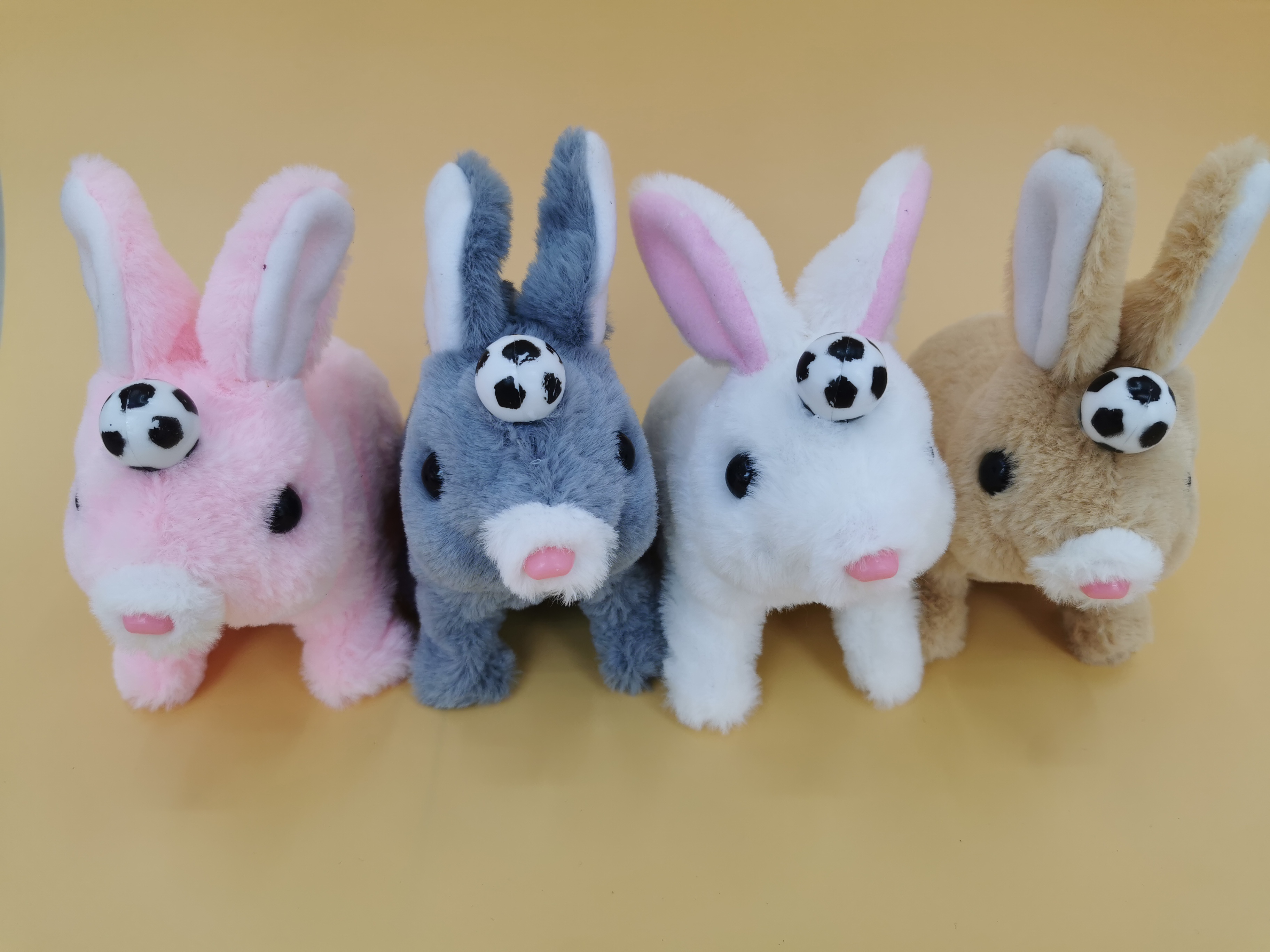 The 2025 new cute plush drawstring tongue-extending electric football rabbit children's simulation toy can walk, move and bark