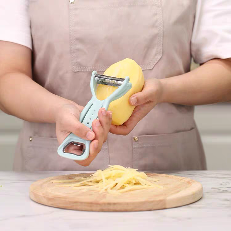 A multi-functional kitchen peeler, shred and bottle opening wonder. A three-in-one peeler and shred wonder detail image 5