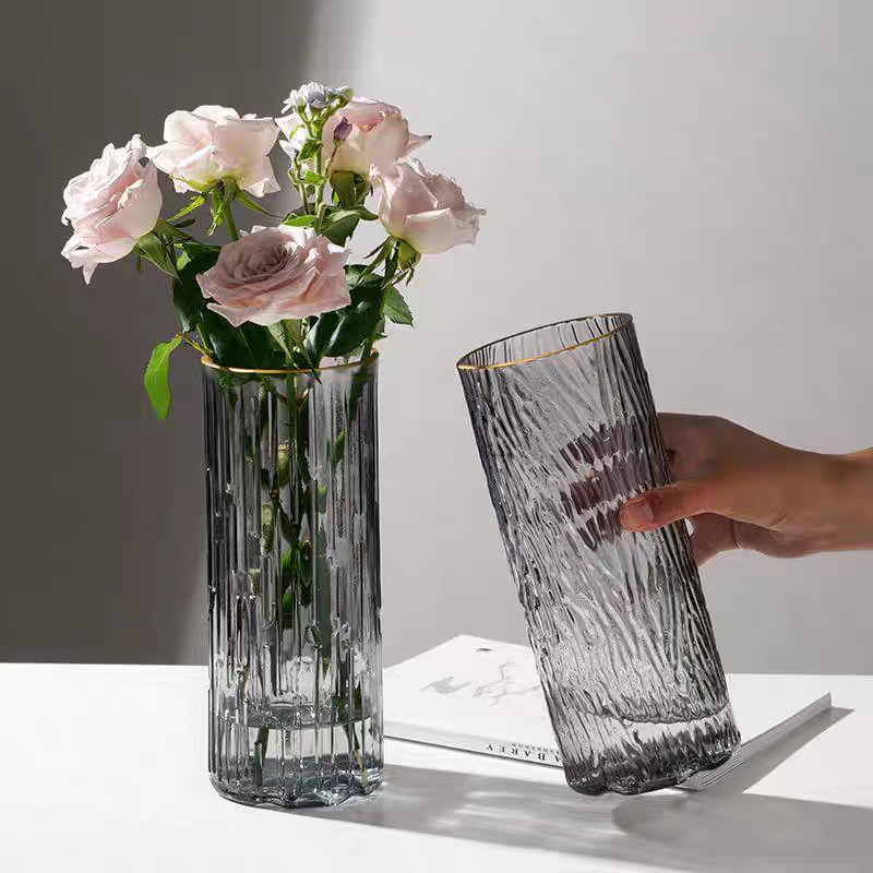 A light luxury glass vase with 25 vertical stripes in gold, simple and transparent, exuding a sense of sophistication. It is an ins feng shui lily hydroponic fresh flower arrangement for the living room details Picture
