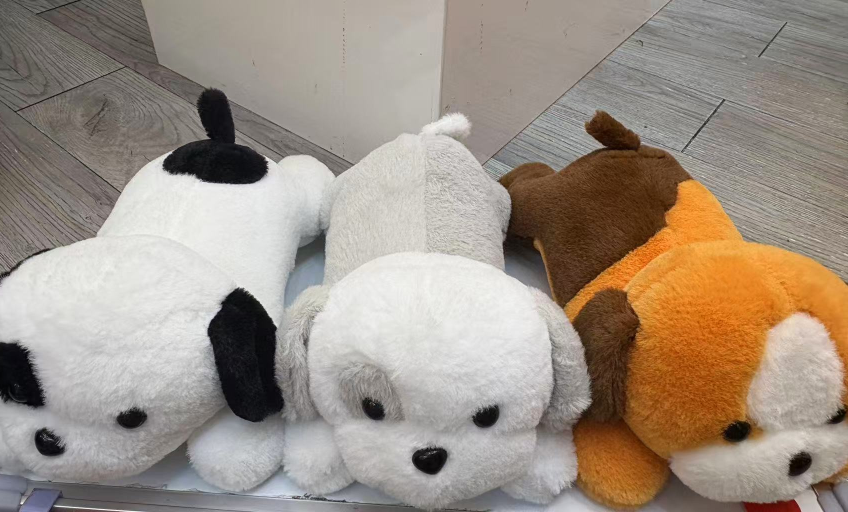 A cute plush toy doll is a birthday gift for my girlfriend to comfort her dog