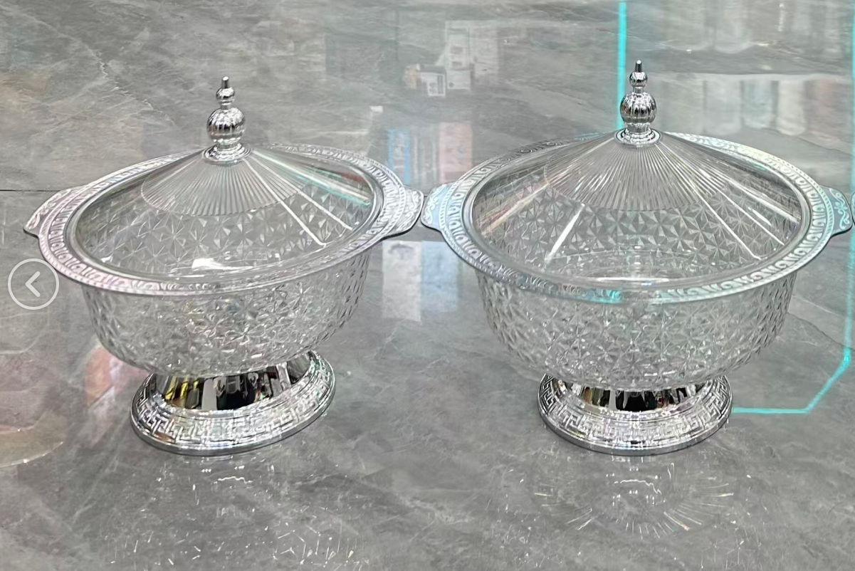 The new covered fruit plate is a special snack storage box for home living rooms. It is made of plastic PET with thickened dust-proof plates and features a silver high foot design, which is elegant and grand
