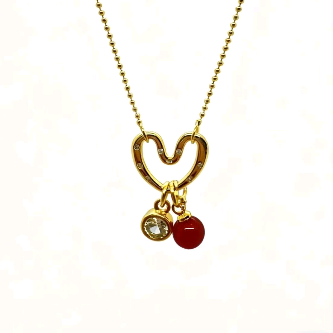 A gold-plated necklace with diamonds, pearls, hearts and copper gold-plated ornaments details Picture