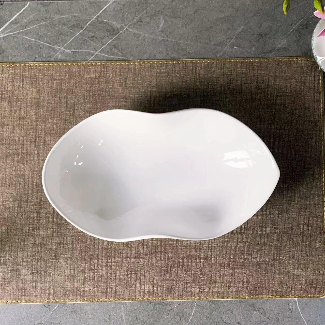 A classic 10.5-inch white porcelain peanut plate with an irregular pinch edge design, suitable for hotels, restaurants, banquets and home use pic 2