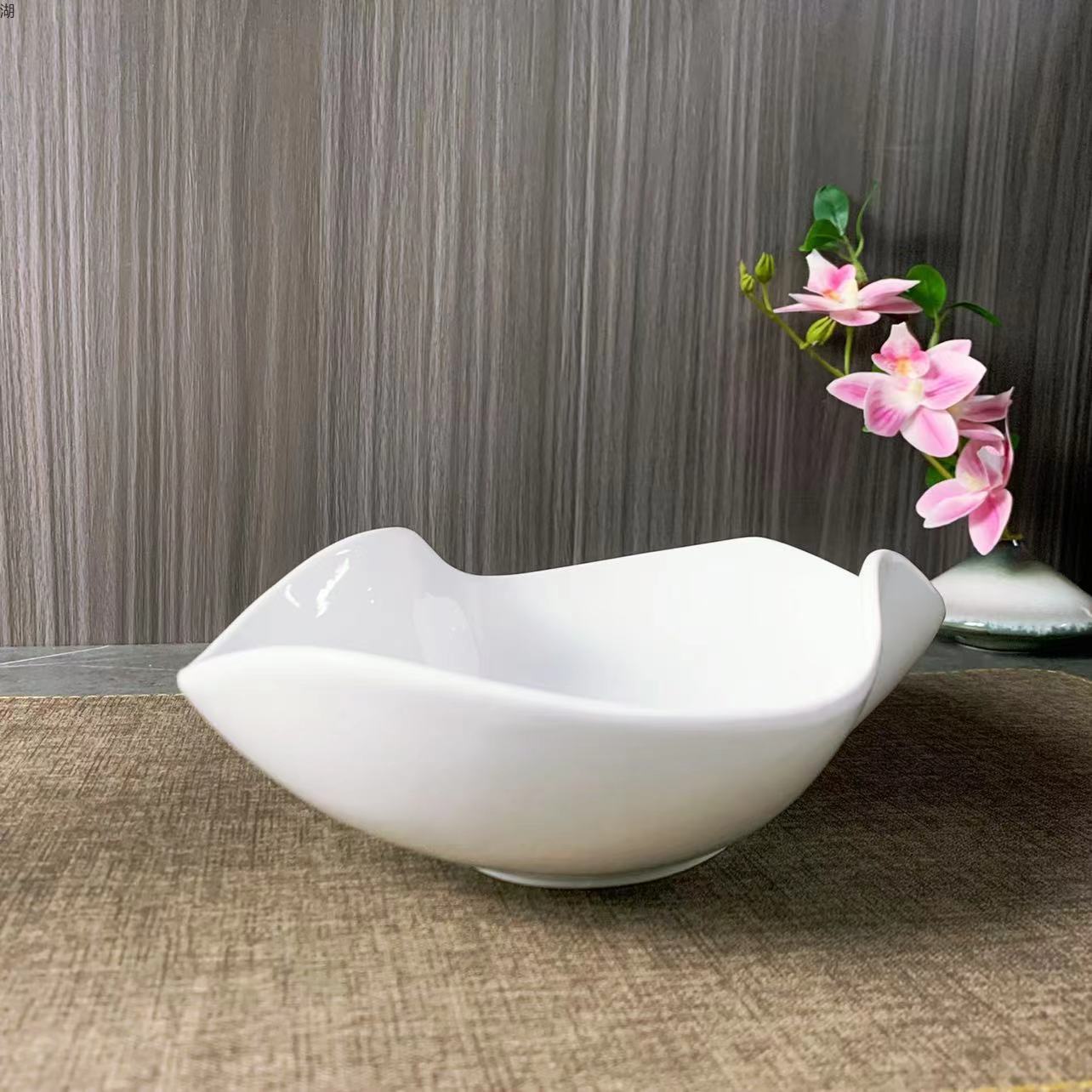 A classic 10.5-inch white porcelain peanut plate with an irregular pinch edge design, suitable for hotels, restaurants, banquets and home use pic 4