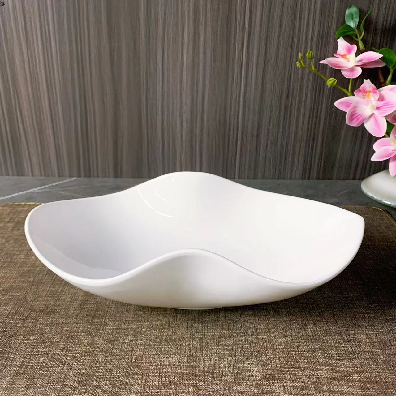 A classic 10.5-inch white porcelain peanut plate with an irregular pinch edge design, suitable for hotels, restaurants, banquets and home use pic 1