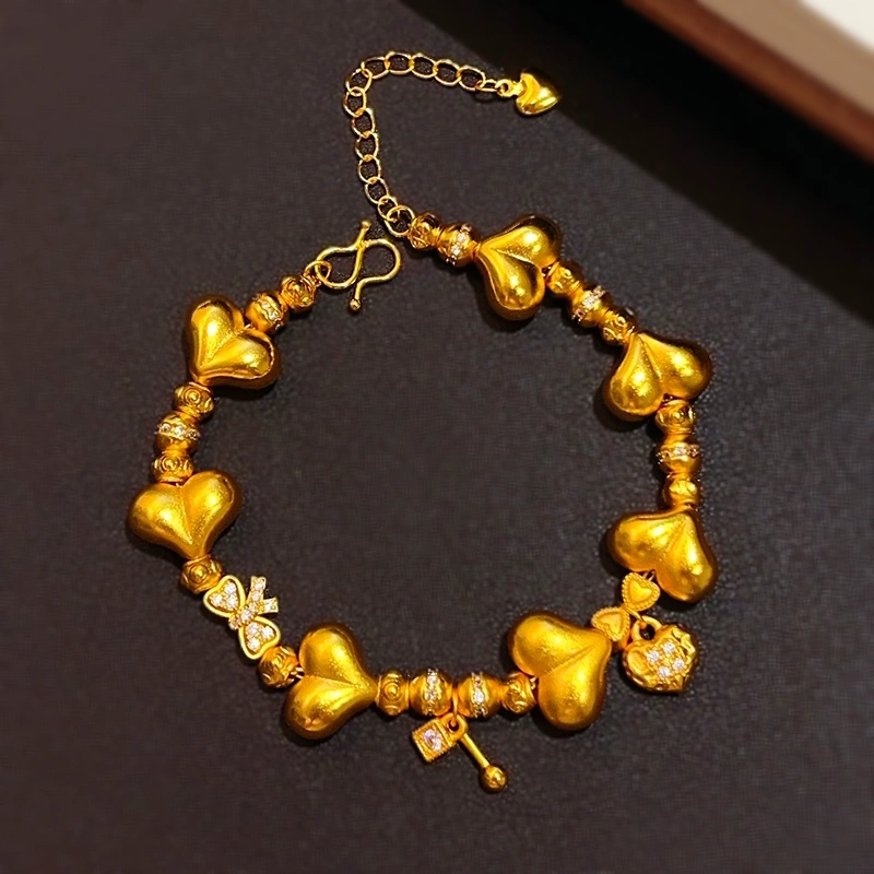This is a delicate heart-shaped bow bracelet with a full circle of heart shapes, the same style of sand gold from Athena Jewelry and Gold store detail image 2